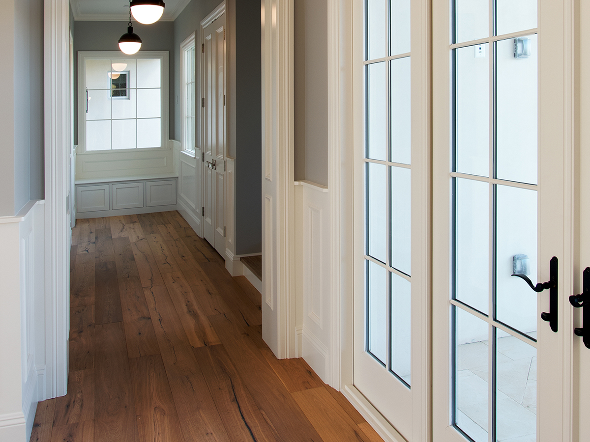 Image viewing down the hallway of a home with glass french doors