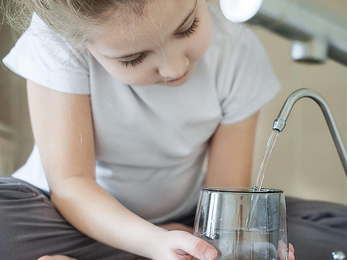 Image of filling up a drinking glass with clean water from the kitchen fauce